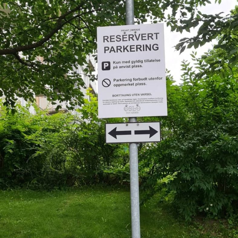 Reservert parkering-skilt på lampe